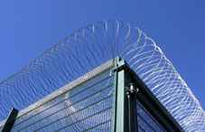 Prison gate with wires at the top